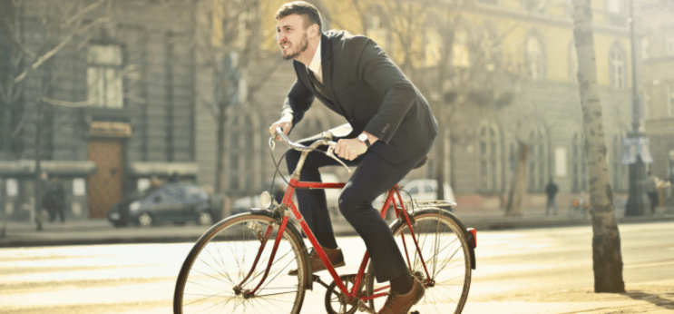 Homem de terno em uma bicicleta