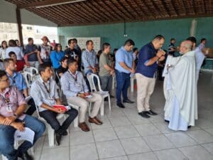 Padre serve o corpo de Cristo em missa que homenageia São José